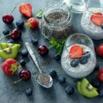 Chia seeds in smoothies with container of seeds