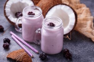 coconut oil in smoothies with half a coconut