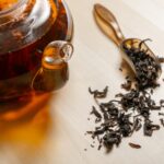 Loose leaf black tea with a teapot of tea