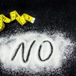 14-day no-sugar diet food list with the word No on sugar next to tape measure