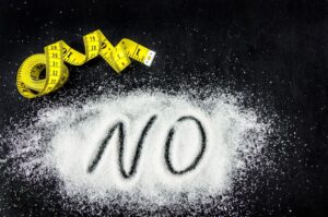 14-day no-sugar diet food list with the word No on sugar next to tape measure