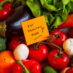 Eat to live 6-week plan with vegetables and a sign saying eat healthy food