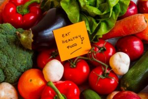 Eat to live 6-week plan with vegetables and a sign saying eat healthy food