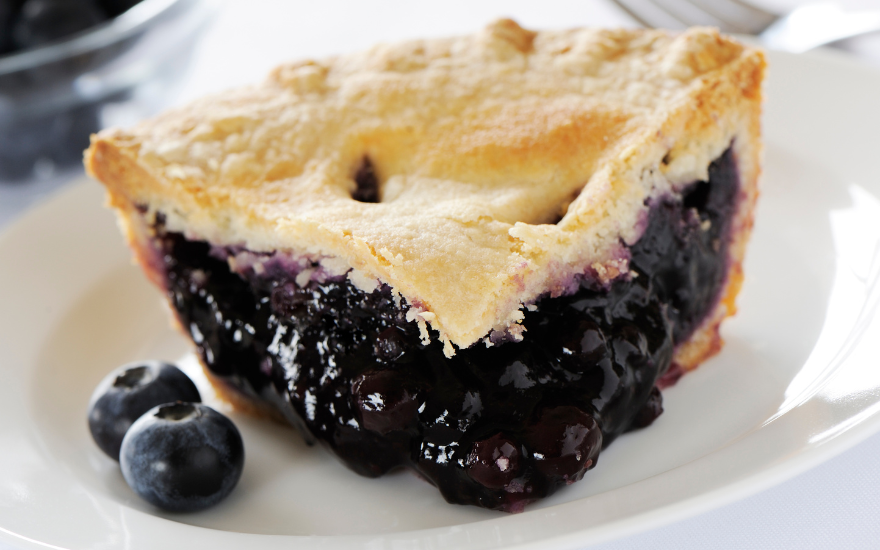 Blueberry pie with frozen blueberries with a slice of pie