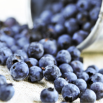 Canned blueberries with tin emptying out blueberries