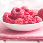 Freeze dried raspberries in a white bowl