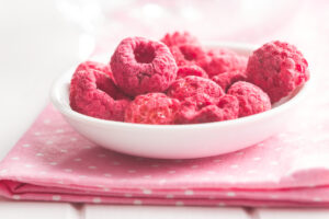 Freeze dried raspberries in a white bowl